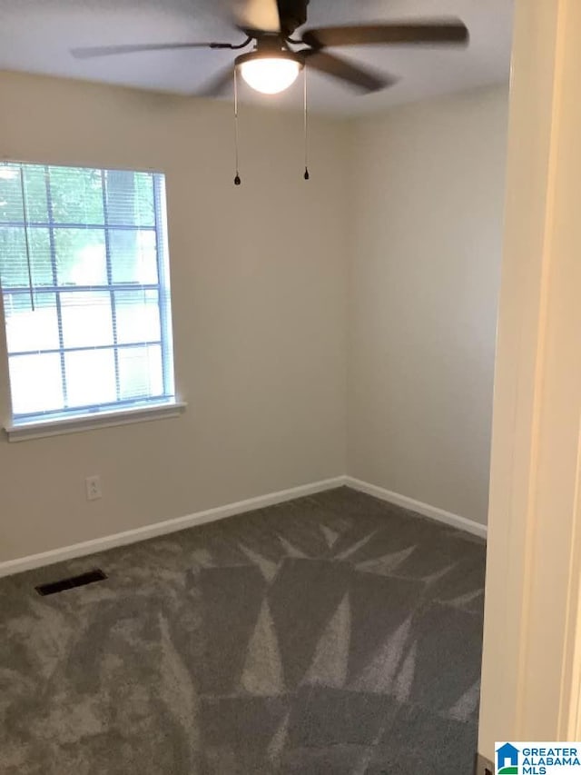 empty room featuring ceiling fan and carpet flooring