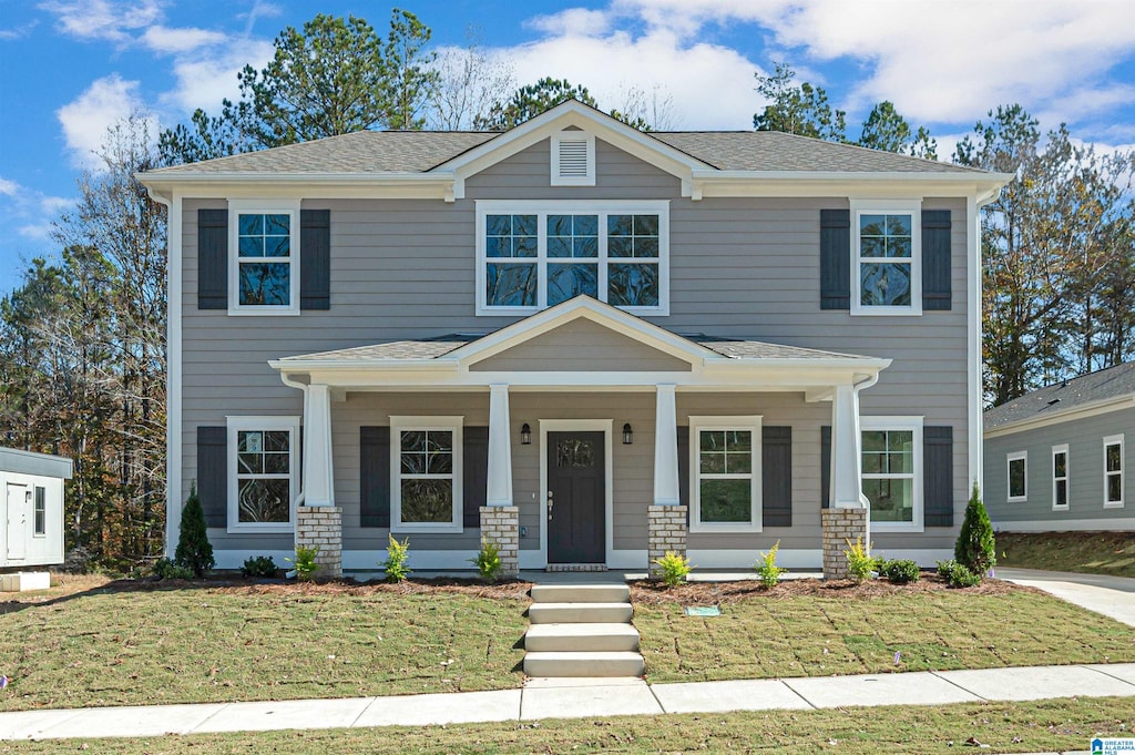 view of front facade with a front lawn and covered porch