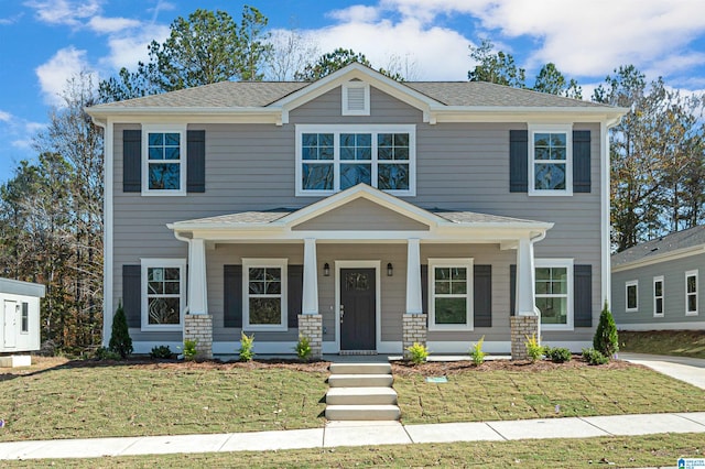 view of front facade with a front lawn and covered porch