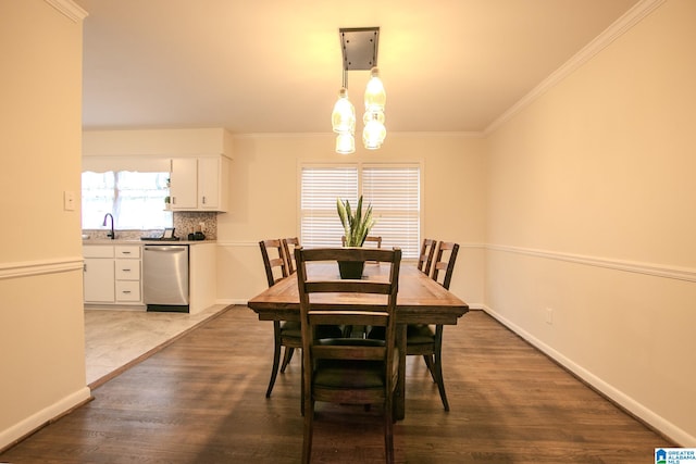 dining room with ornamental molding, dark hardwood / wood-style floors, and sink