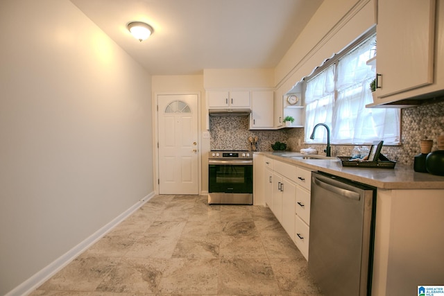 kitchen featuring white cabinets, tasteful backsplash, stainless steel appliances, and sink