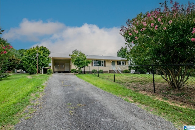 single story home featuring a front lawn and a carport