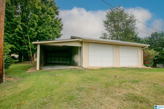 garage with a lawn and a carport