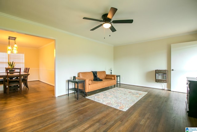 living room featuring ceiling fan with notable chandelier, ornamental molding, heating unit, and dark hardwood / wood-style floors