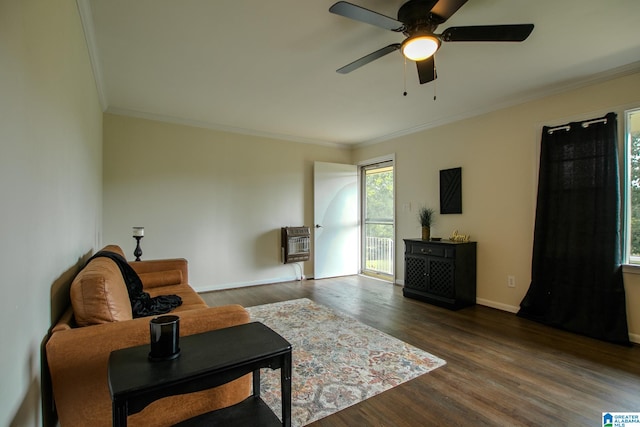 living room with crown molding, ceiling fan, heating unit, and dark hardwood / wood-style flooring