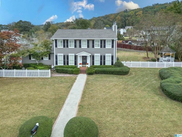 colonial inspired home with a front yard