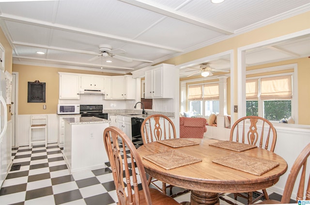 dining area with ornamental molding, sink, and ceiling fan