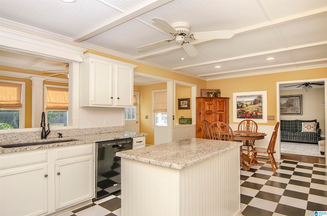 kitchen featuring a kitchen island, ornate columns, black dishwasher, sink, and white cabinets