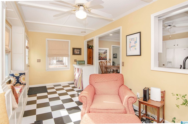 sitting room with ornamental molding and ceiling fan