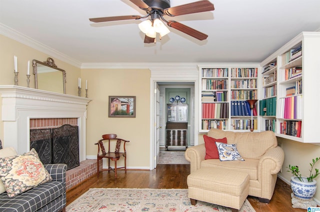 living room featuring ornamental molding, a fireplace, dark hardwood / wood-style floors, and ceiling fan