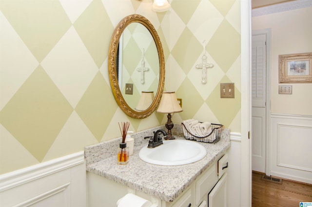 bathroom with vanity and hardwood / wood-style floors