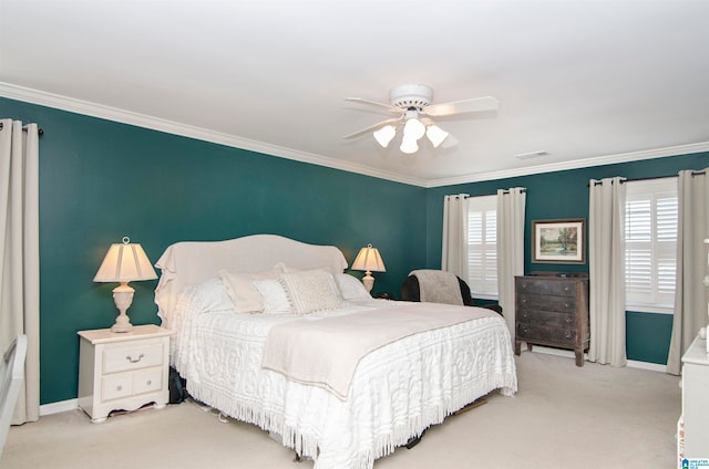 carpeted bedroom featuring ornamental molding and ceiling fan