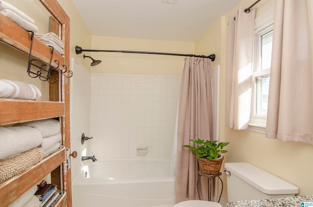 bathroom with toilet and shower / bathtub combination with curtain