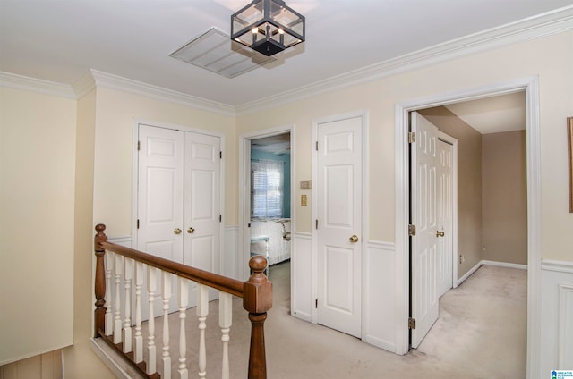 corridor with light carpet and crown molding