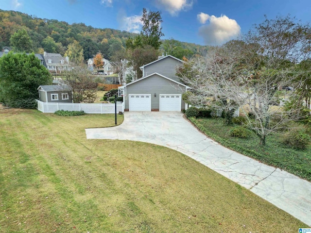 view of front of house featuring a garage and a front lawn