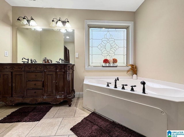 bathroom featuring vanity, a tub to relax in, and tile patterned flooring