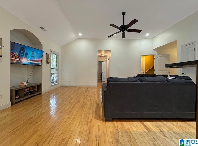 living room with lofted ceiling, light wood-type flooring, and ceiling fan