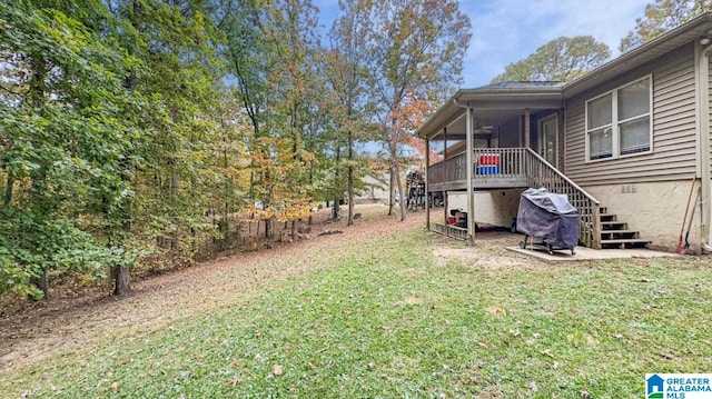 view of yard with a sunroom and ceiling fan