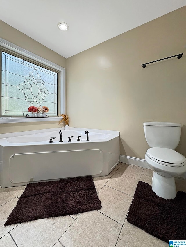 bathroom featuring toilet, a bath, and tile patterned flooring