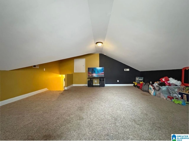 additional living space featuring carpet and vaulted ceiling