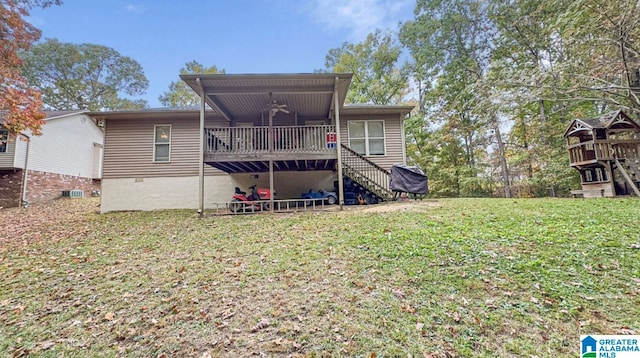 rear view of house featuring a wooden deck, a yard, and central air condition unit