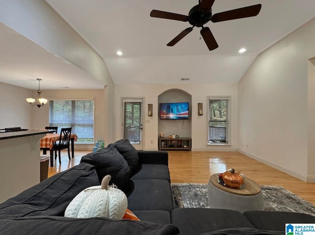 living room with vaulted ceiling, light wood-type flooring, and a healthy amount of sunlight