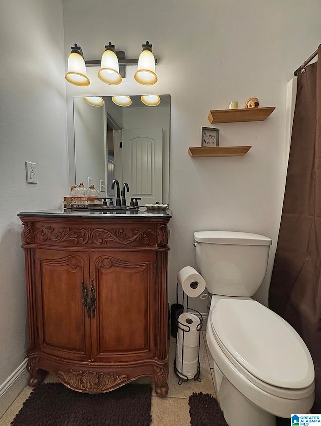 bathroom featuring vanity, toilet, and tile patterned floors