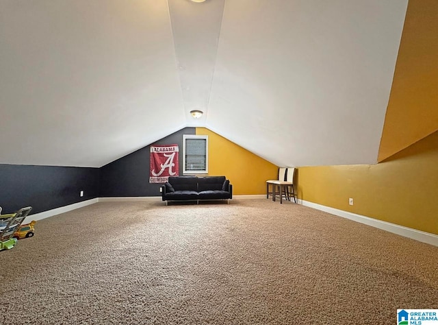 additional living space with vaulted ceiling and carpet flooring