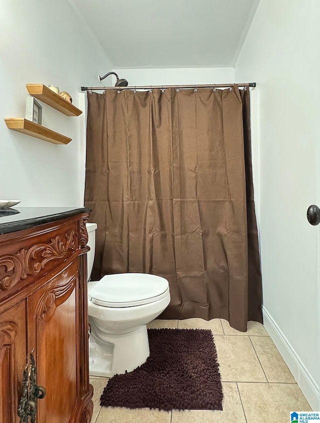 bathroom with vanity, toilet, tile patterned floors, and walk in shower