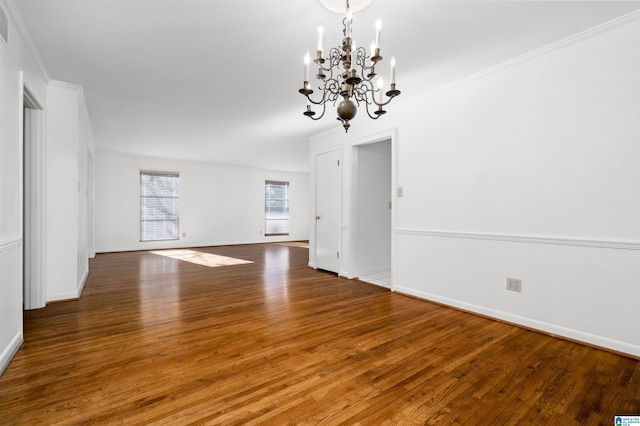 interior space featuring hardwood / wood-style floors, crown molding, and a chandelier