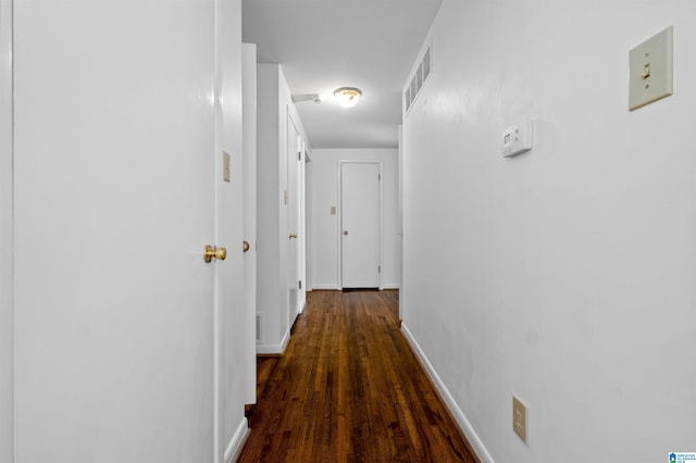 hallway with dark hardwood / wood-style floors