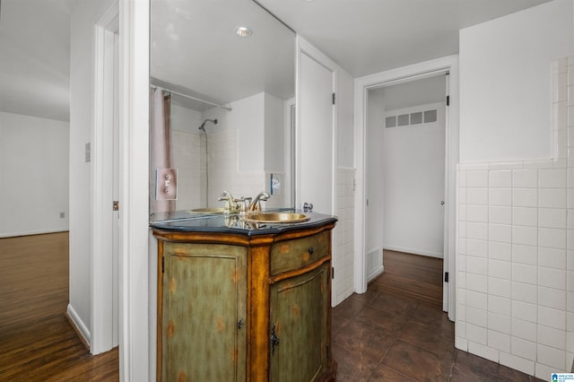 bathroom featuring vanity, a shower with curtain, wood-type flooring, and tile walls