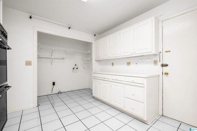 clothes washing area featuring light tile patterned flooring