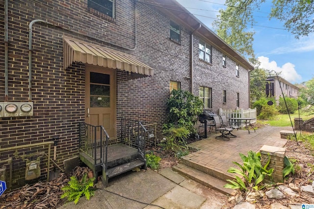 view of exterior entry featuring a patio