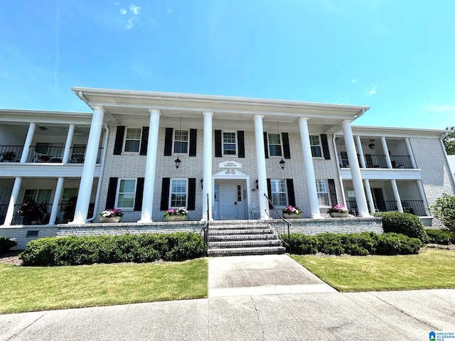 neoclassical home with a balcony