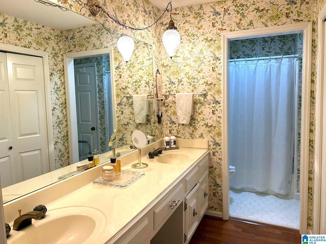 bathroom with vanity, a shower with shower curtain, and hardwood / wood-style flooring