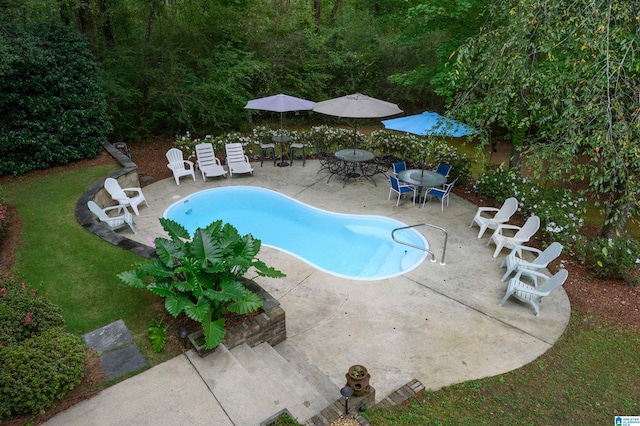 view of swimming pool with a yard and a patio