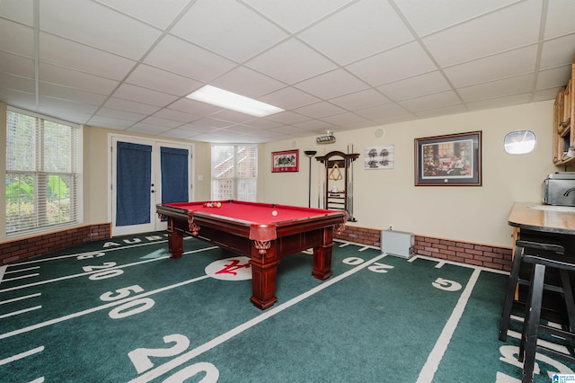 rec room featuring a drop ceiling, dark colored carpet, and pool table