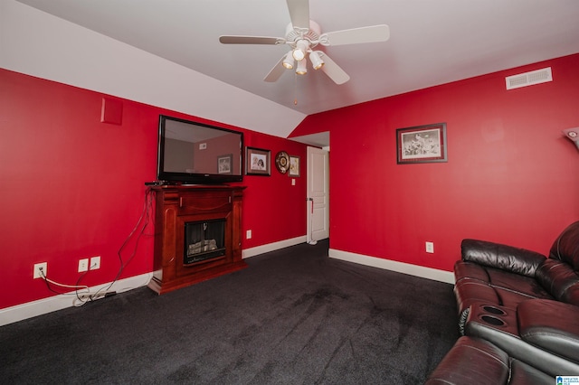 living room featuring dark colored carpet and ceiling fan