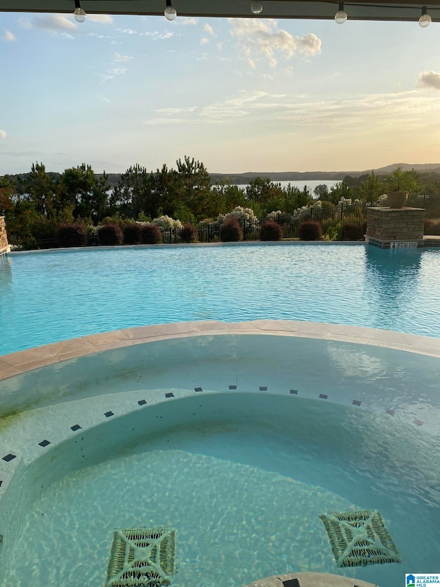 view of pool at dusk