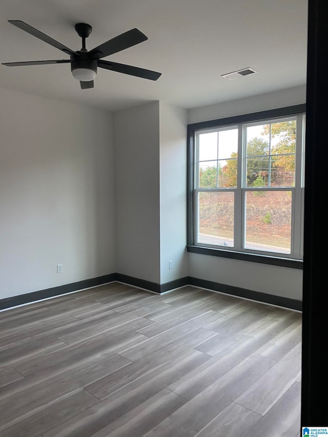 spare room featuring light hardwood / wood-style floors and ceiling fan