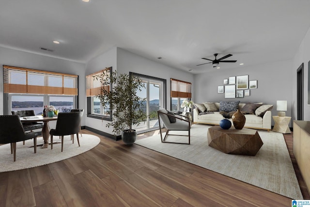 living area with recessed lighting, a ceiling fan, baseboards, visible vents, and dark wood finished floors