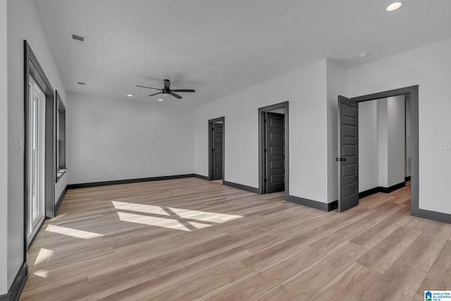 unfurnished bedroom with light wood-style flooring, visible vents, and baseboards