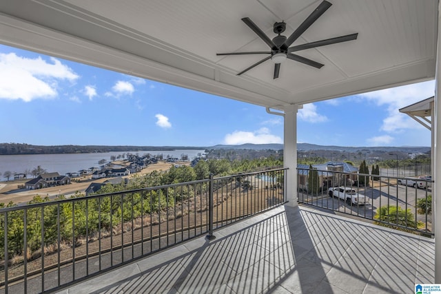 balcony with a ceiling fan and a water view