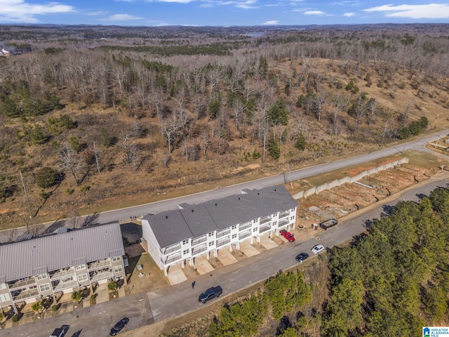 drone / aerial view featuring a wooded view