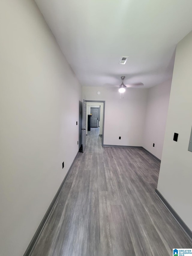 empty room with ceiling fan and wood-type flooring