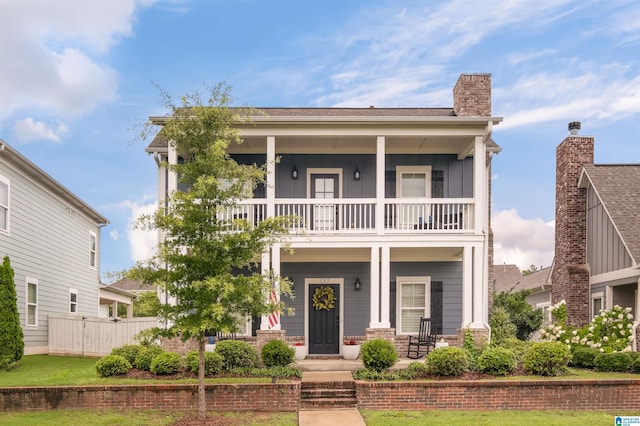 view of front facade with a balcony and covered porch