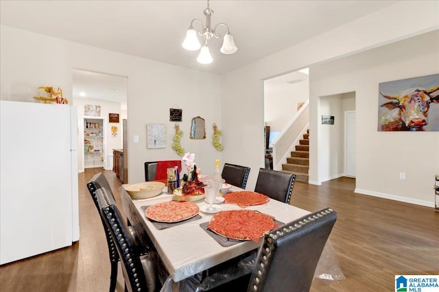 dining room featuring dark hardwood / wood-style flooring and a chandelier