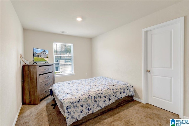 bedroom featuring light colored carpet