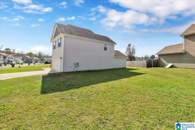 back of property featuring a lawn and a garage